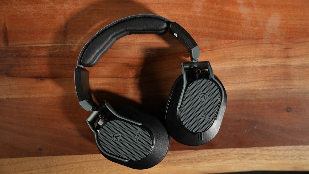 Austrian Audio Hi-X65 headphones mesh grilles open-back design wooden background